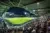 Packed stadium during a night football match with excited fans in the stands